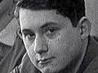 A black and white historical portrait of a young man with dark hair, looking intently directly at the camera.