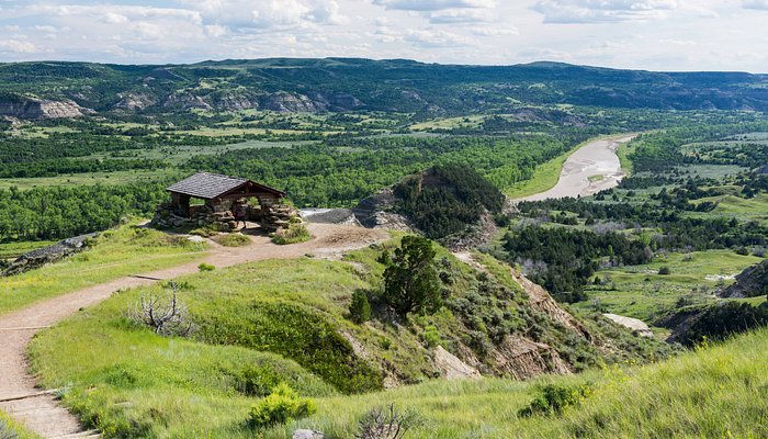 Historic CCC stone shelter perched on a grassy ridge overlooking the Little Missouri River valley