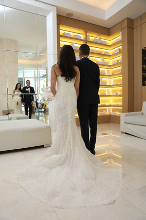 Bride and groom looking into mirror