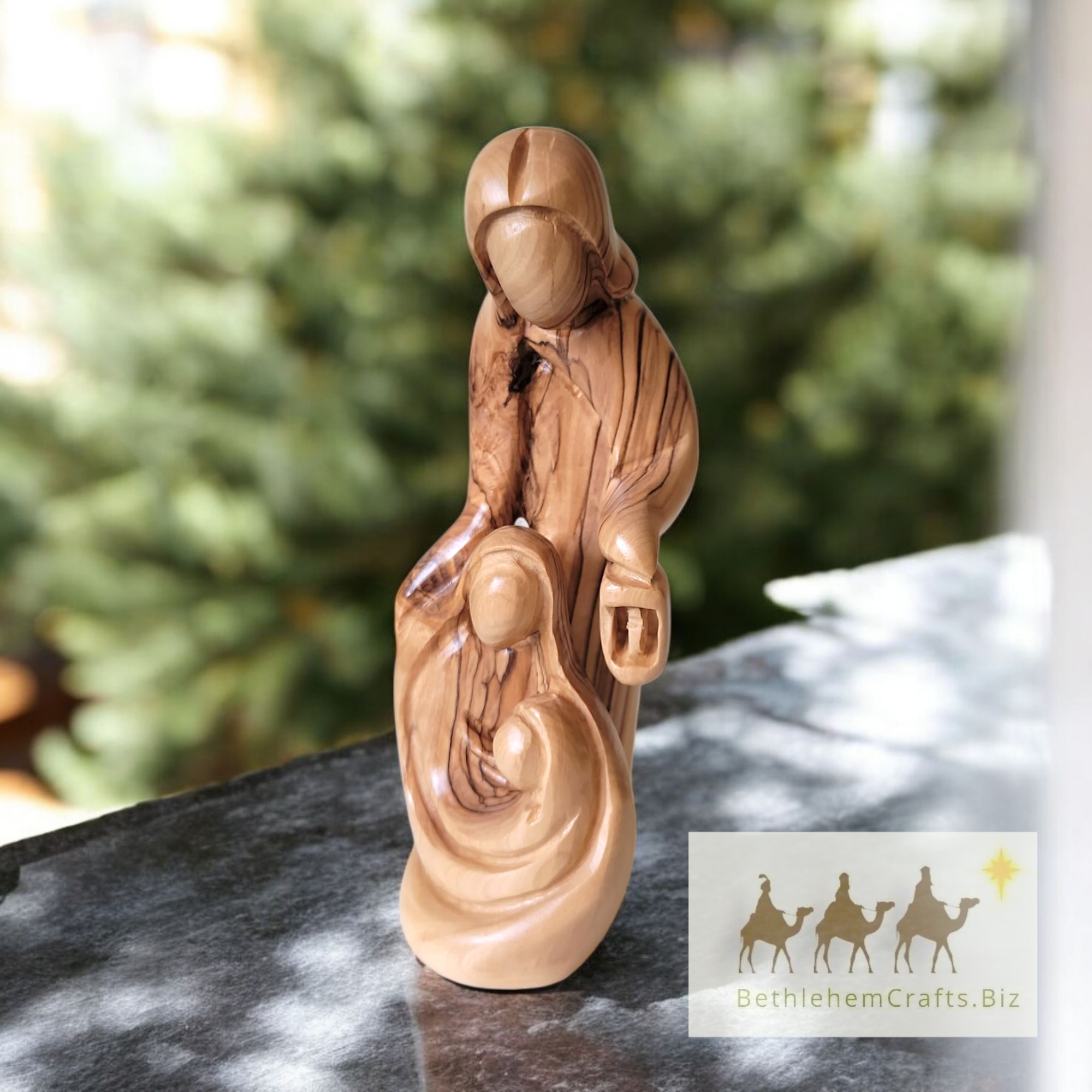 faceless, minimalist olive wood statue of the Holy Family with Joseph holding a lantern modern Christmas decor from Bethlehem