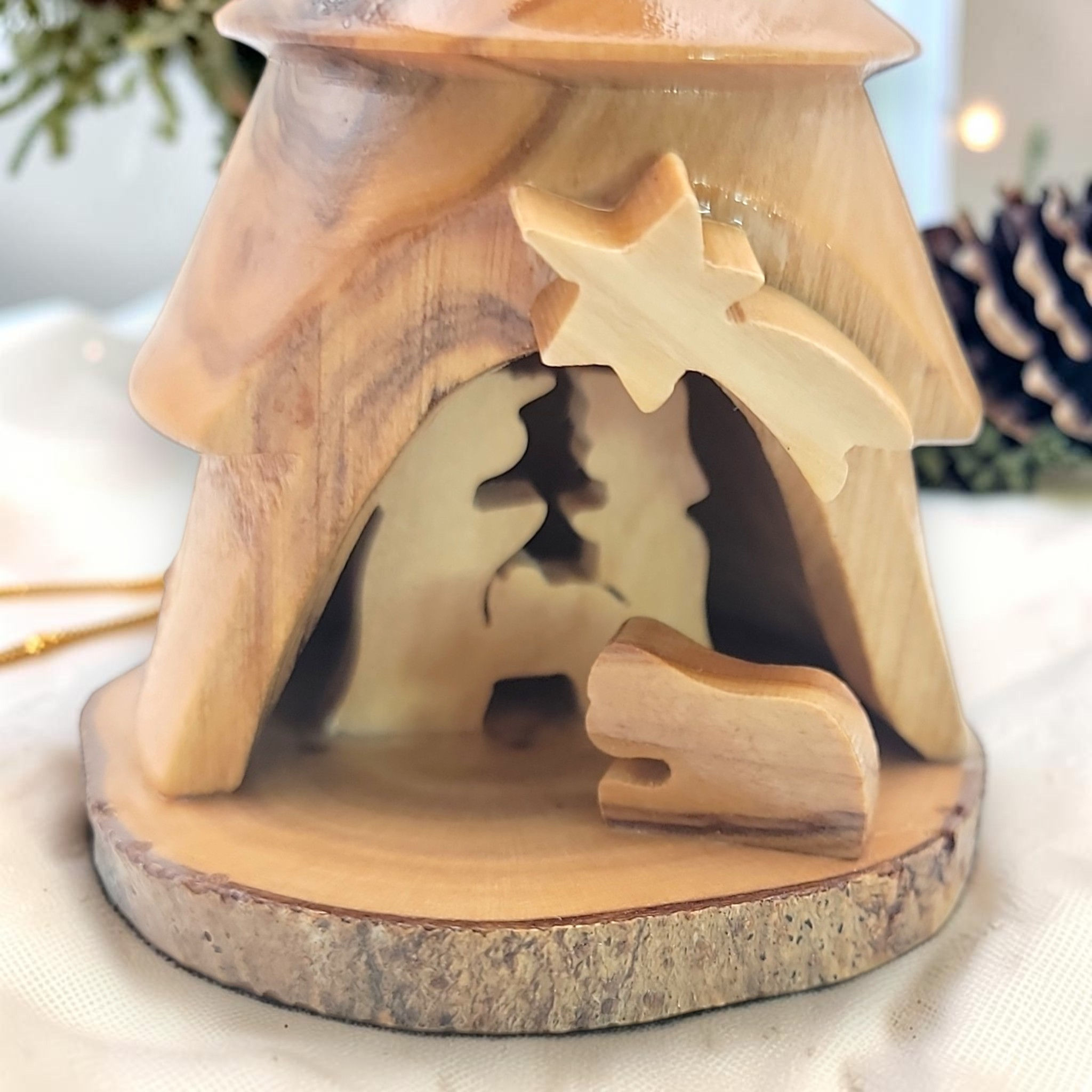 Close-up of Mary, Joseph and Baby Jesus inside an olive wood tree ornament