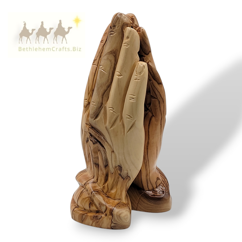 Thumbnail: hand carved sculpture of two praying hands with an olive tree grove in the background for Christian home decor from Holy Land