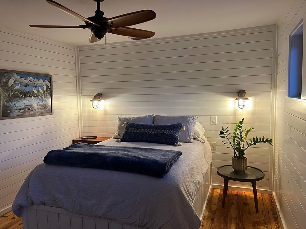 The first bedroom has a comfortable queen size bed and ceiling fan.