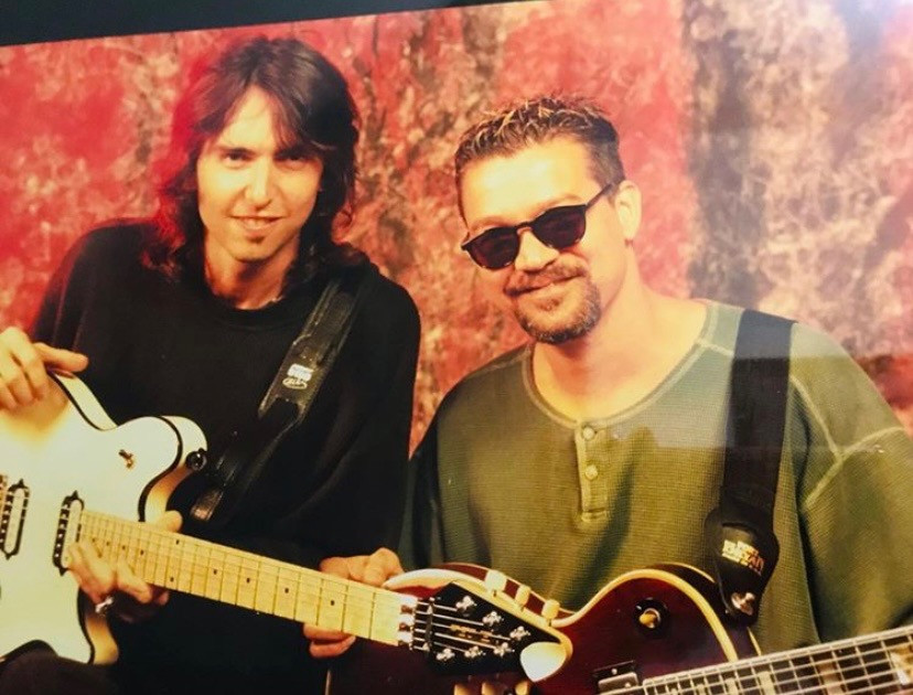 Damon Johnson with Eddie Van Halen, both holding guitars.