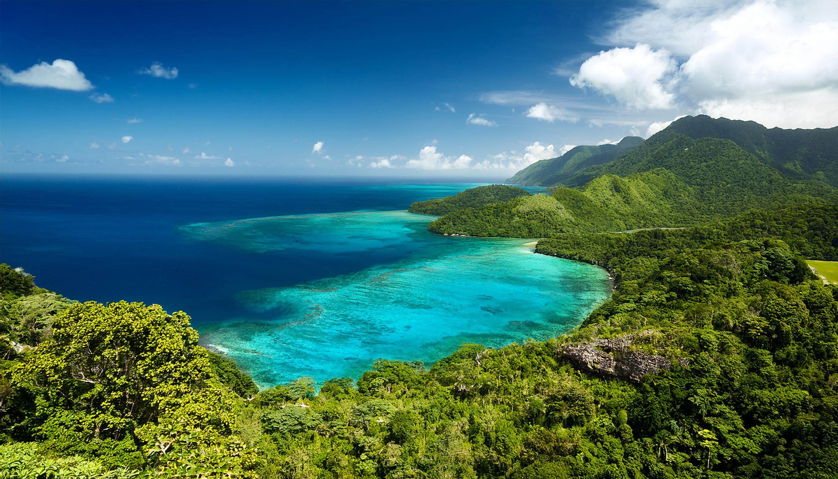 The Blue Mountains in Jamaica showing the clear turquoise waters below.