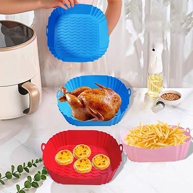 The image shows two silicone liners for an air fryer in blue and red colors. They are placed inside air fryer baskets with cooked food on them – one displaying a whole roasted chicken and the other showing egg tarts. To the right side of these images is a bottle of oil spray and fried foods, suggesting these liners help in cooking such items in an air fryer. This image visually demonstrates how these reusable liners can be used within an air fryer to cook different types of food while making cleanup easier.