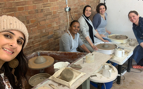 Three students and Sarah learning mindfulness pottery