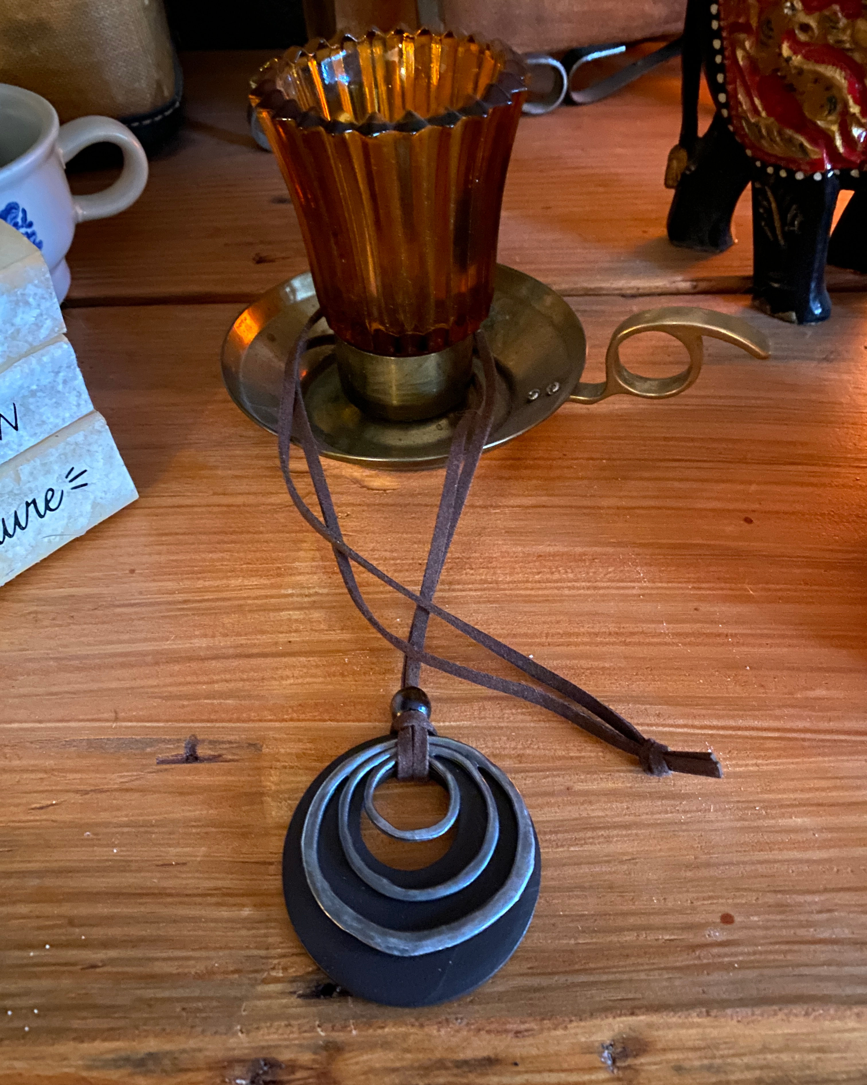 Long necklace with suede rope and wooden circle with silver metal design