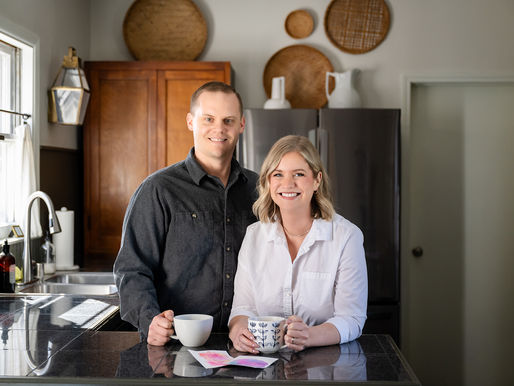 Owners Ashley and Tyler standing in a kitchen smiling