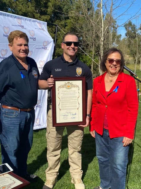 1 Chairman Doug Chaffee handing out the resolution to Sergeant Mike Bryant