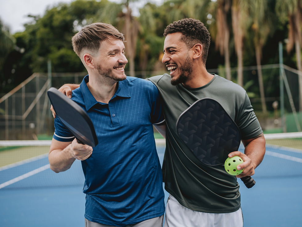 Two men playing pickleball on a pickleball court