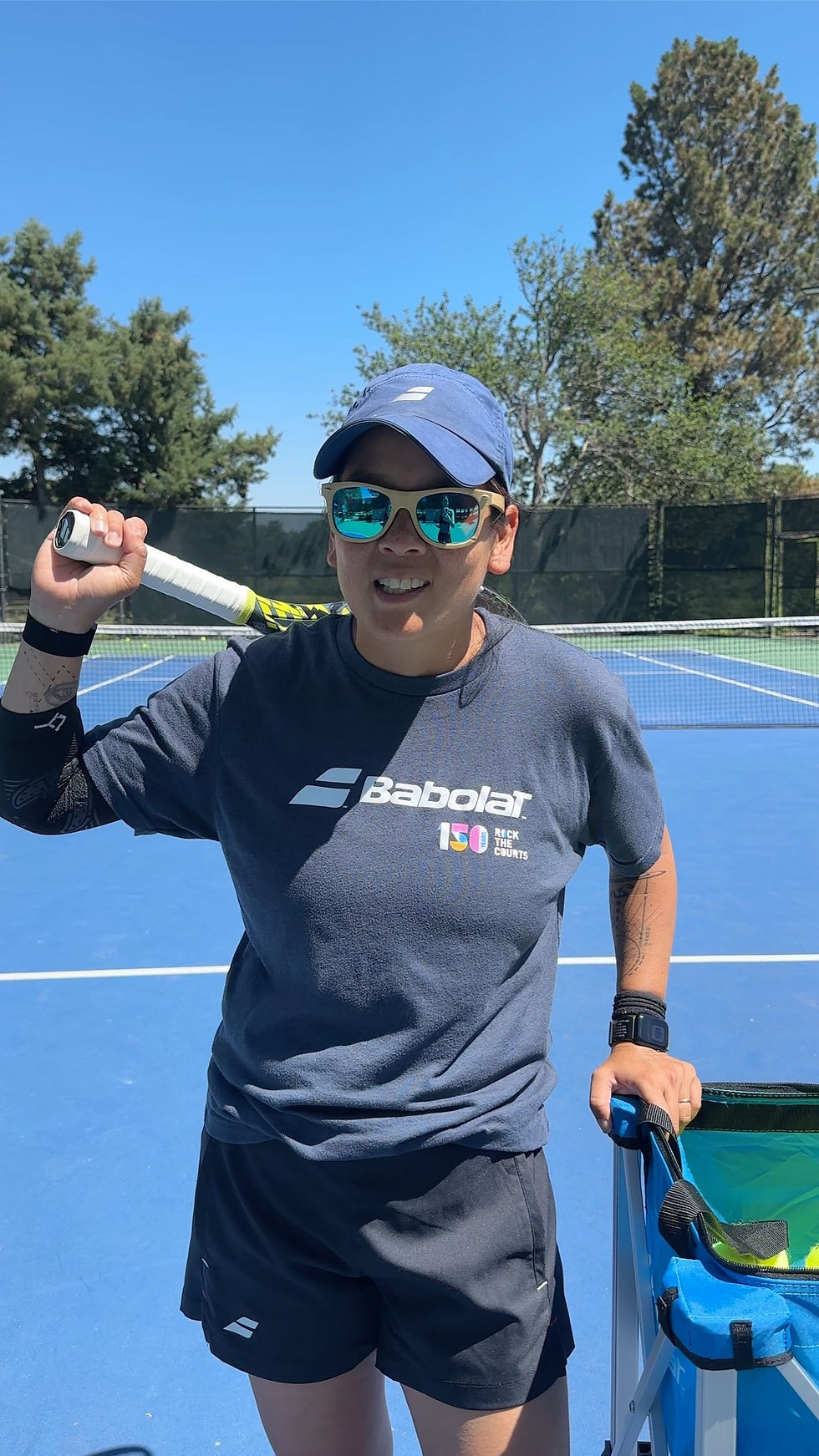 Coach Ming performing tennis drills