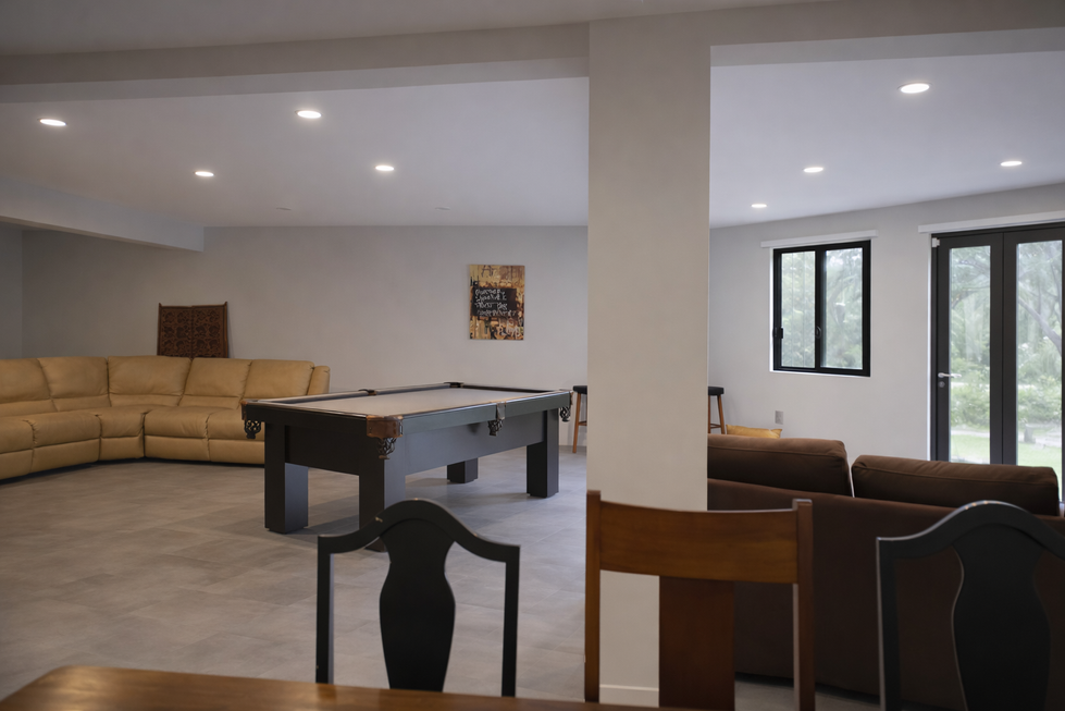 Lower-level lounge with pool table and seating.