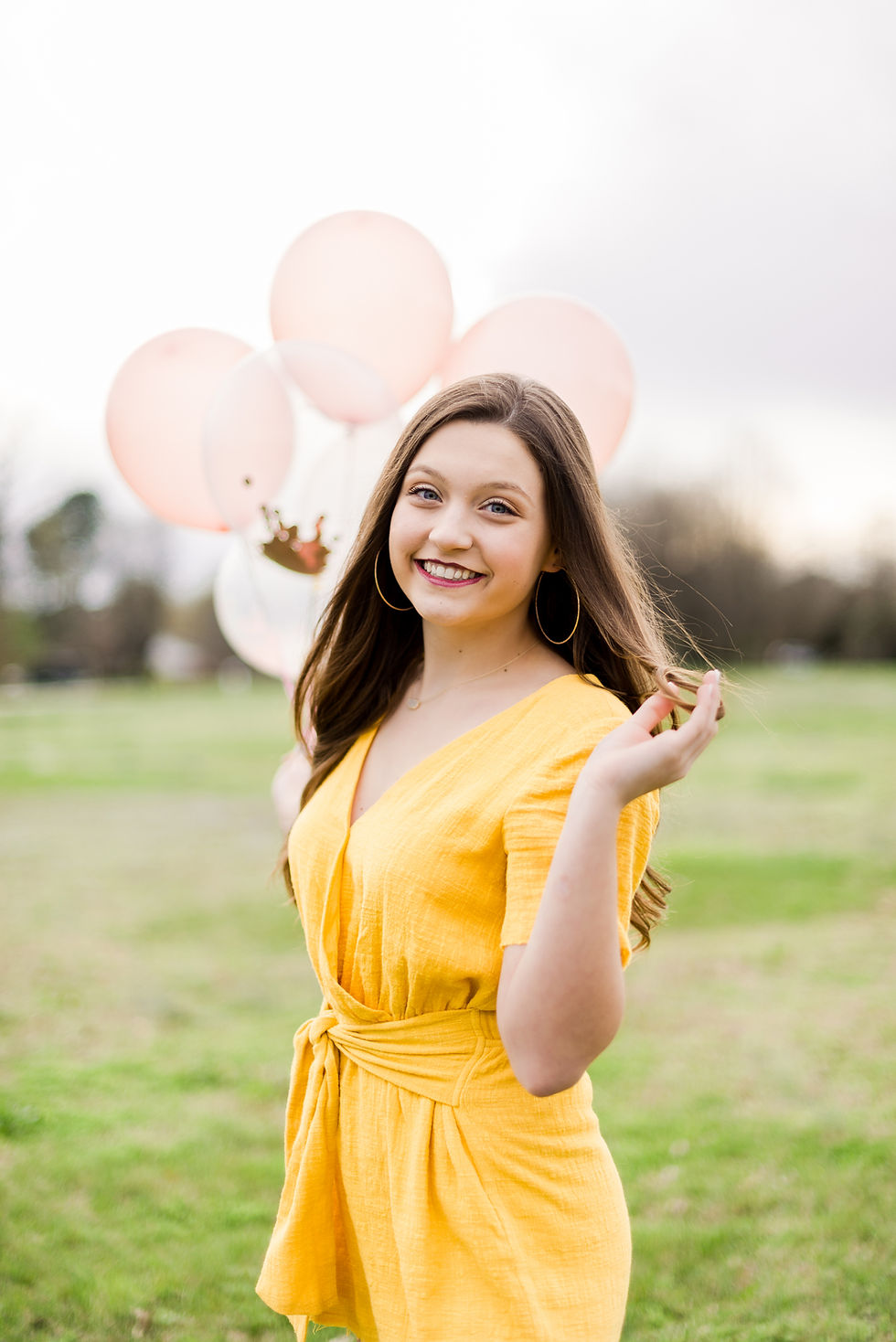 Manila High School Senior photos girl in yellow romper with balloons. jonesboro photographer. jonesboro, arkansas photographer. jonesboro senior photographer. manila senior photographer. senior photos in jonesboro arkansas.