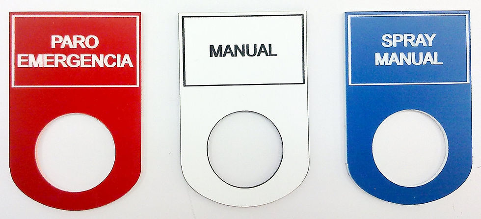 Botoneras para maquinaria en gravoplay rojo, blanco y azul con indicaciones grabadas.