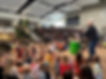 Our Sunday School students listen to Sunday worship on the steps of the church atrium.