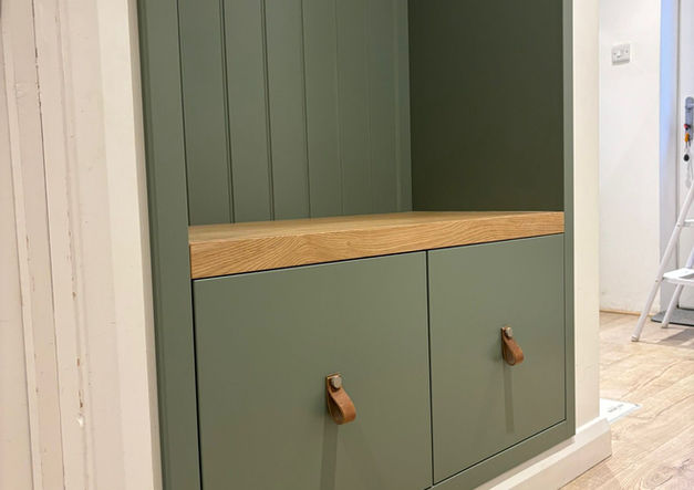 Painted hallway bench with hidden storage and wall panelling detail.