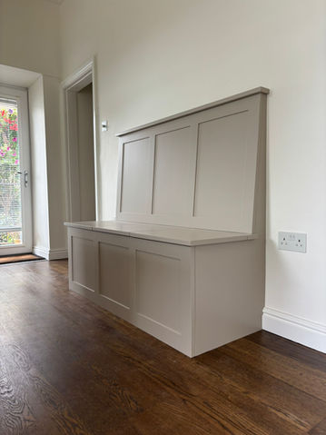 Painted hallway storage bench with panelled back