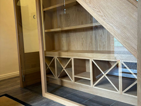 Under-stairs wine and whisky storage, made to measure