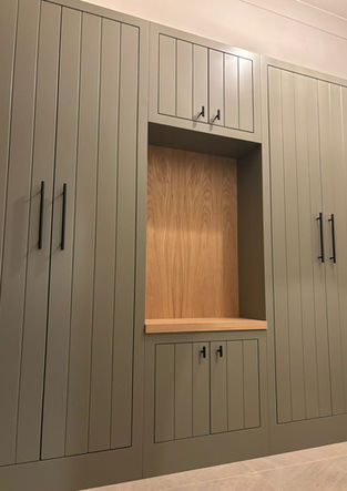 Built-in wardrobe with integrated open niche and warm timber interior.