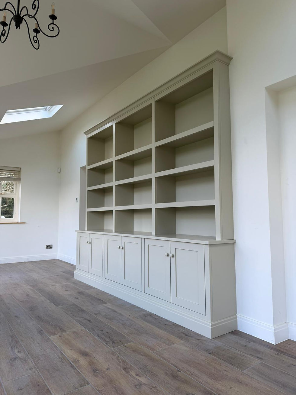 Built-in painted shelving unit with cabinet base installed in a Harrogate home