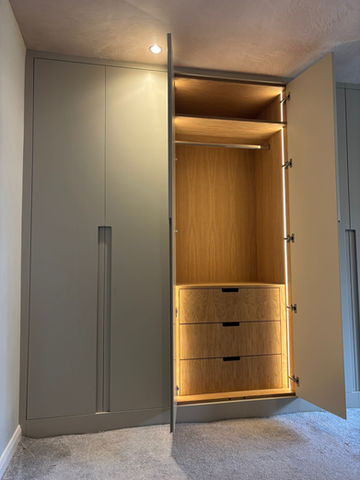 Fitted wardrobe with open section, internal drawers, and tall hanging space.