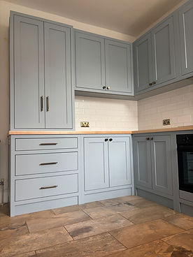 Bespoke kitchen with painted cabinets, stone worktops and integrated appliances
