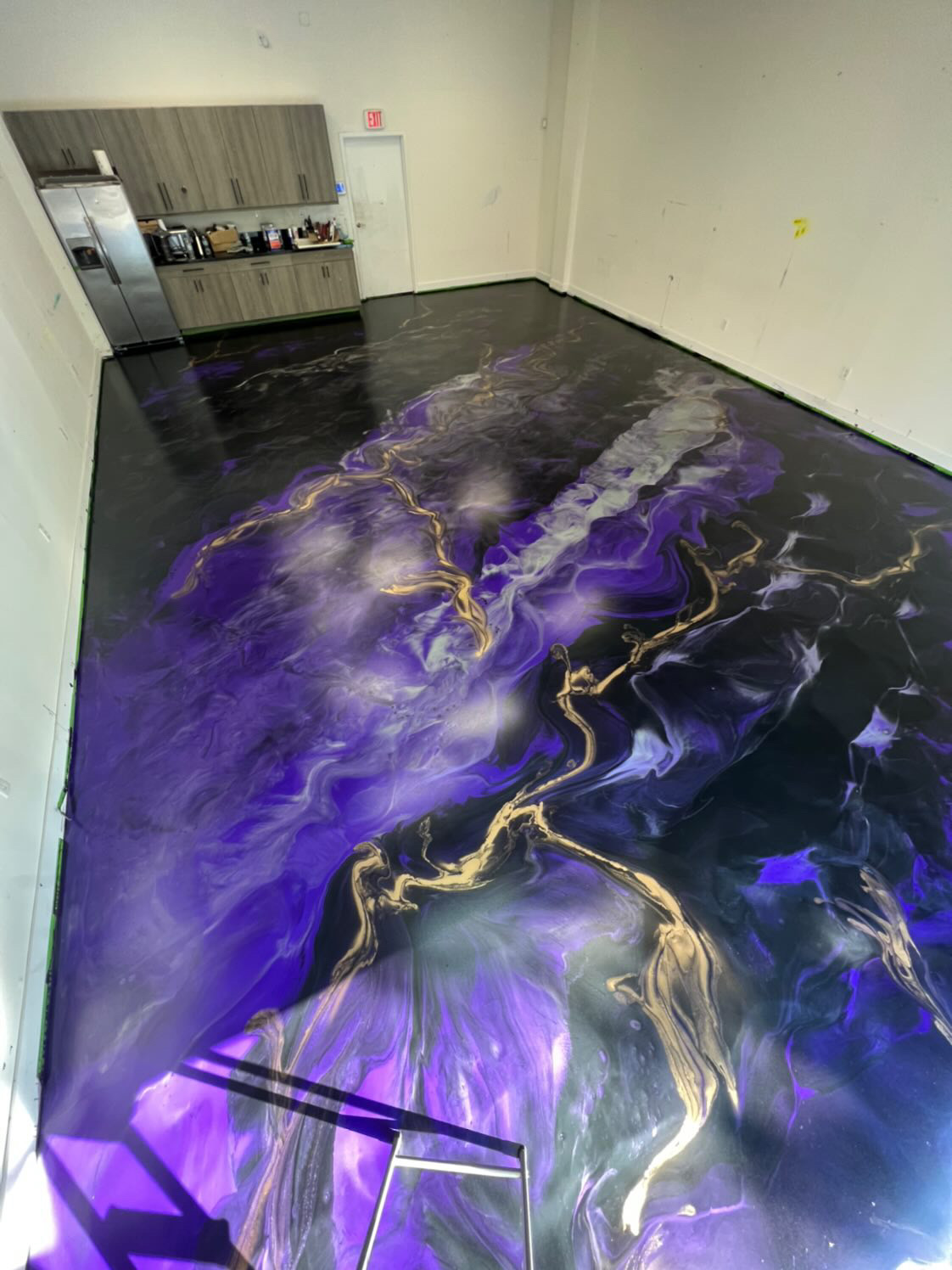 Metallic epoxy garage floor with gold and copper swirl pattern