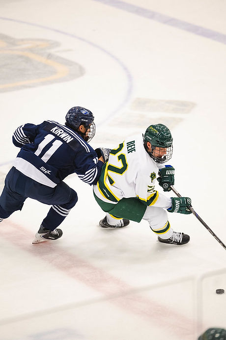 Forward Nick Reif (22) spinning away from Bailey Kirwin (11) on February 7. 2026. (Photo Credits Brockport Athletics)
