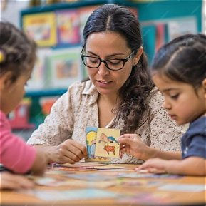 Teacher supporting a pupil with visual aids