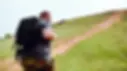 Man rucking on a countryside trail wearing weighted backpack — promoting RUK-X outdoor fitness