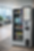 Smart vending machine in an office offers snacks and drinks. Touchscreen displays options. Two people work by a window with city views.