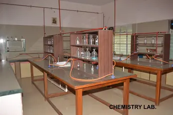 CHEMISTRY LAB. Empty chemistry laboratory with tables, glassware, and fume hoods.
