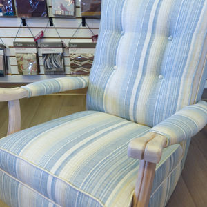 Close-up of restored rocking chair upholstered in JF Fabrics Kinney blue striped fabric.