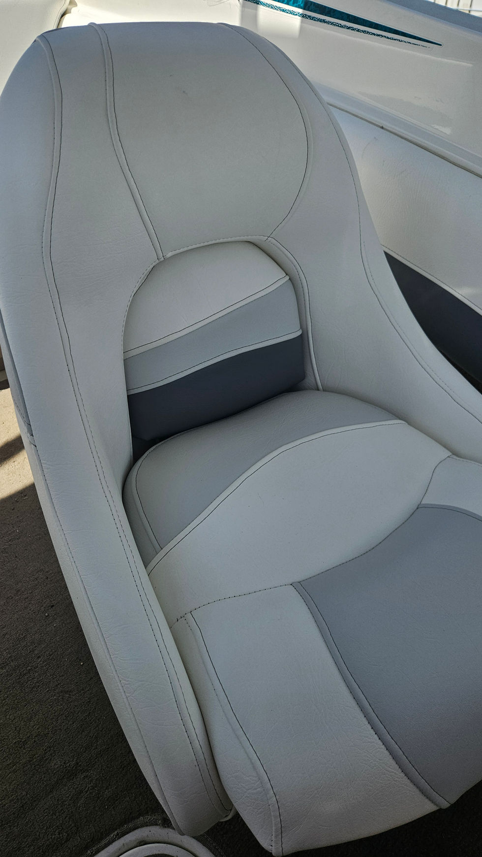 White and grey boat seat close-up showing seam work and contoured vinyl upholstery.