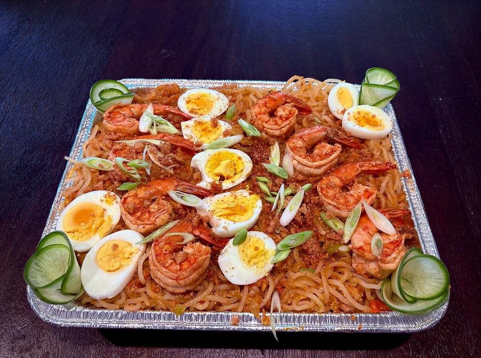 Eye-level view of a colorful Filipino pancit noodle dish on a plate
