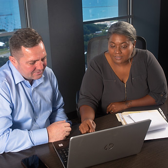 Kei and Adrian reviewing accounting data.