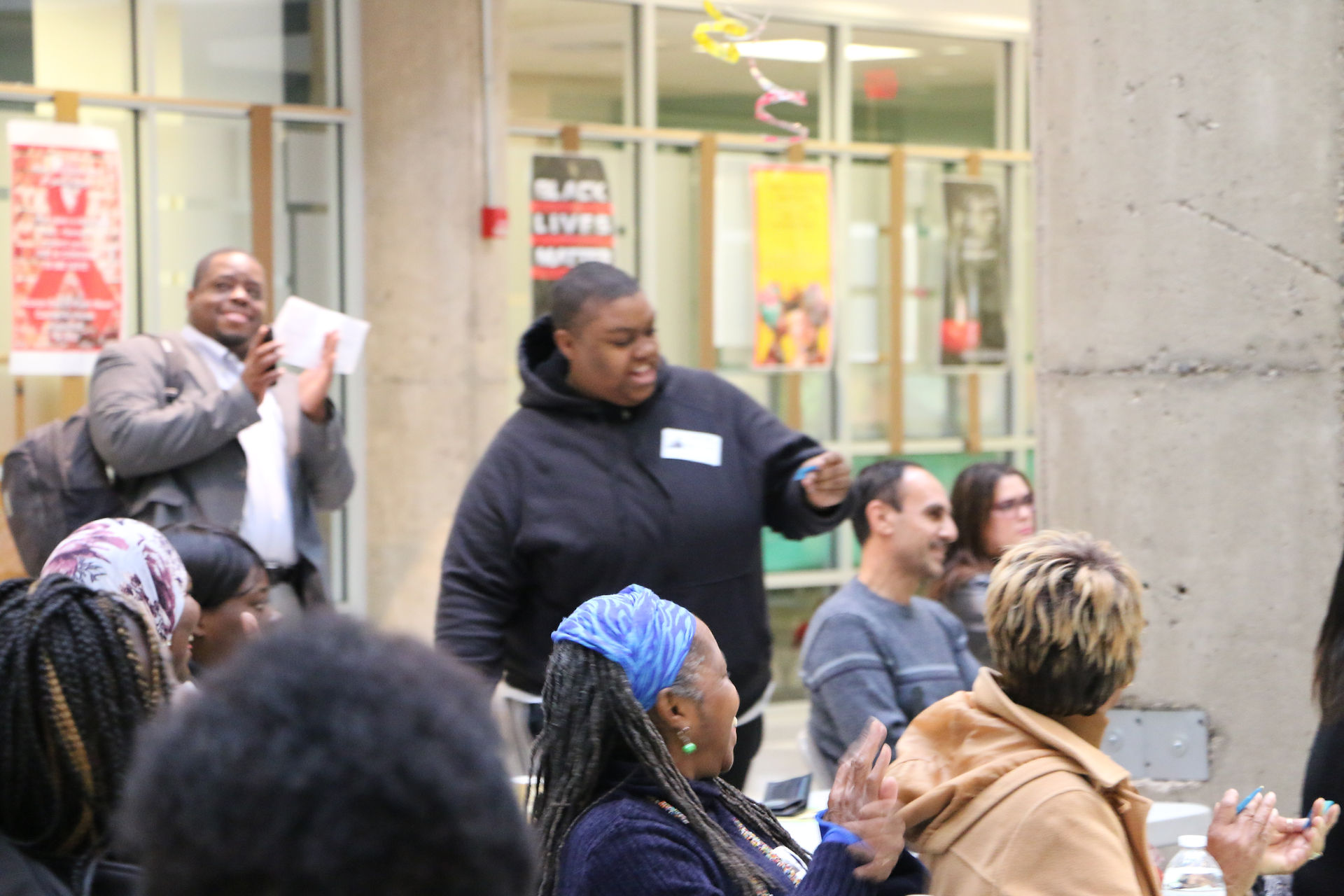 Audience members cheer as a fellow parent is identified as a raffle winner for Disney on Ice