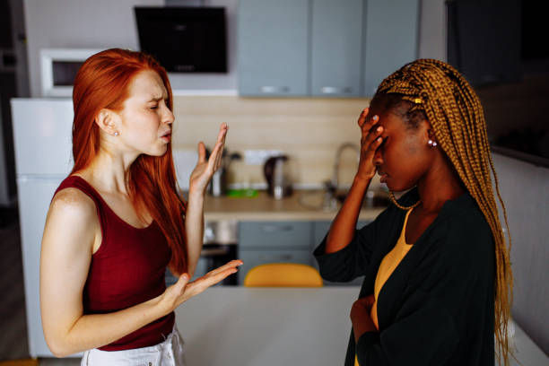 A couple fighting in a kitchen.