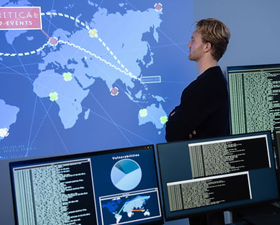 Back View in the Cyber Security Control Center Operator Working. Multiple Screens Showing