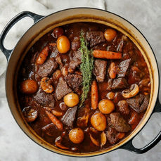 The Beef Bourguignon recipe, Beef braised low and slow in Burgundy wine with bacon, carrots, pearl onions and baby potatoes until the sauce turns dark, glossy and entirely itself. The French classic that rewards every hour it spends on the stove.