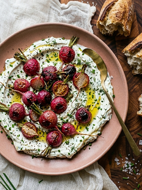 Roasted radishes lose their sharpness in the oven and become something sweeter and more tender — served over garlicky yogurt and finished with fresh chives. A light, unexpected spring side dish.