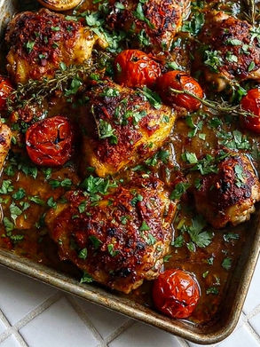 Sheet Pan Harissa Chicken- A whole chicken cut into pieces, marinated in harissa and roasted in one pan with tomatoes, onions and fresh coriander. Bold, minimal effort, and entirely worth making any night of the week.