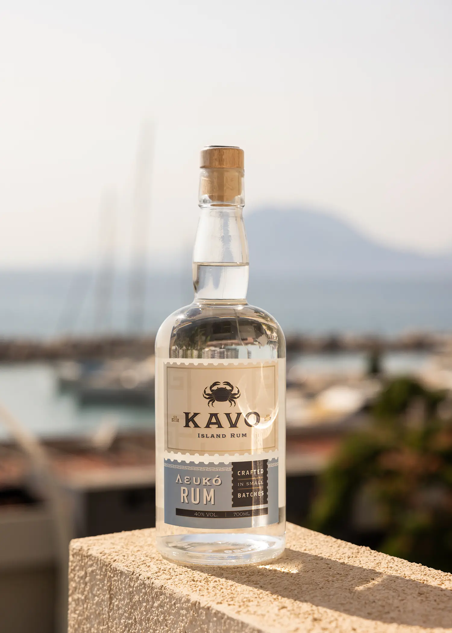 A bottle of Kavo Rum with Patras, Greece in the background