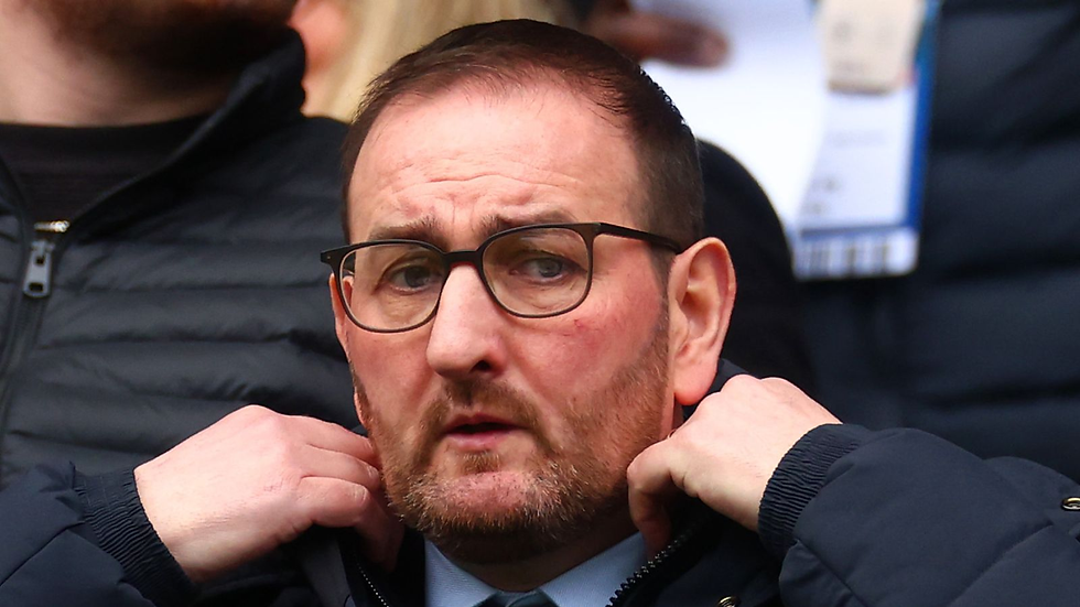 Kevin Thelwell tucks his collar in