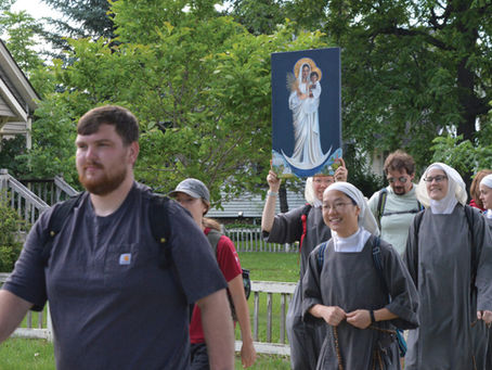 Pilgrims from the Diocese of New Ulm and the Sisters of Mary Morning Star walk through Marshall and Ghent carrying a replica of Our Lady of the Prairie during the Pilgrimage of Hope. Photo by Deb Gau, Marshall Independent.