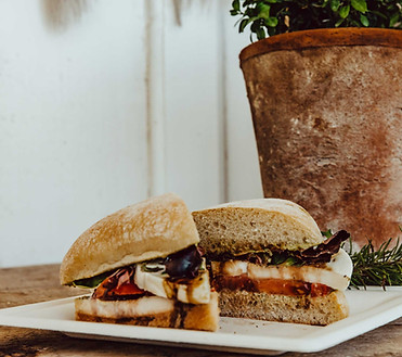 A caprese sandwich drizzled with balsamic vinegar