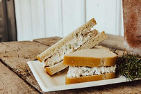 A photo of a chicken salad sandwich on white bread.