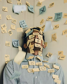 Young man covered in sticky notes, work
