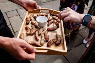 Relaxed guests chatting and enjoying canapés at Houchins wedding